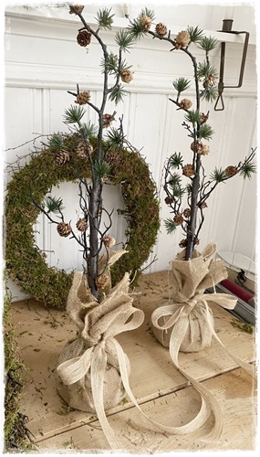 Mooi dennenappel boompje van 70 cm. groot wat in een jute zak staat met strik (niet van echt te onderscheiden)